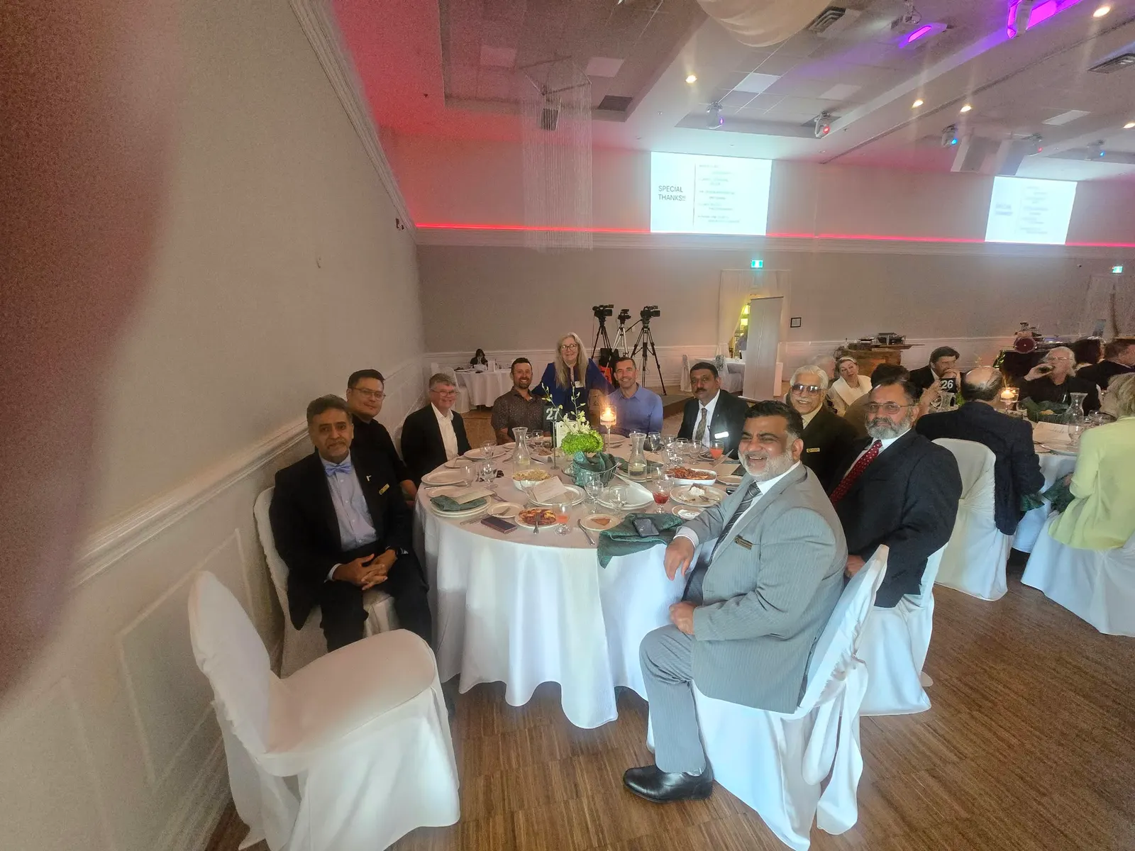 Guests seated at a round table during a PCBO dinner.