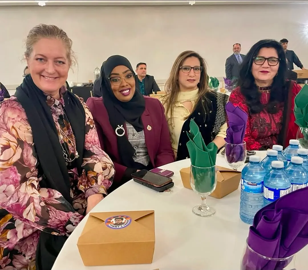 Four women seated together at a PCBO event.
